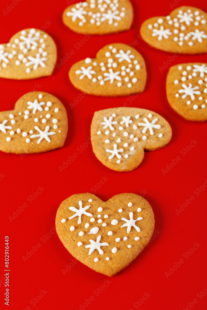 beautiful hand-baked cookies in the shape of a heart on a red background beautiful hand-baked cookies in the shape of a heart on a red background