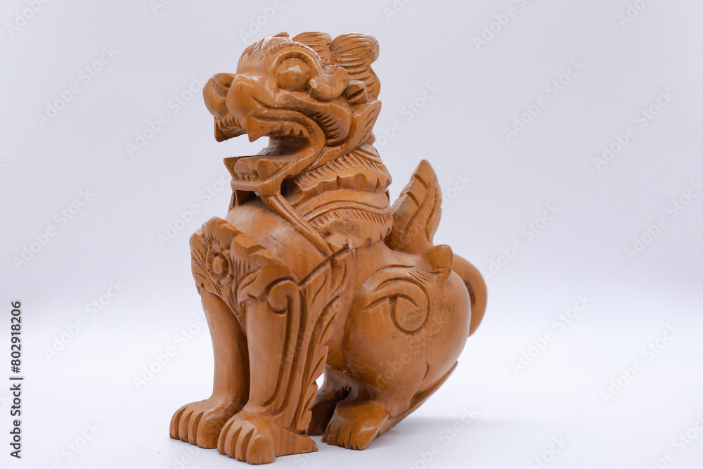 A traditional symbol of Myanmar, the Burma Guardian Lion is depicted in wooden sculptures. 