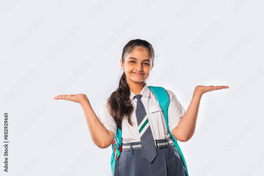 Portrait of cheerful Indian asian teenage schoolgirl with school uniform and backpack Portrait of cheerful Indian asian teenage schoolgirl with school uniform and backpack