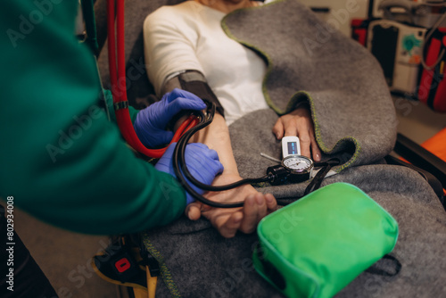 A doctor checks the pressure inside an ambulance