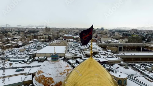 Beautiful snowy day in Qom, Iran. Holy shrine of lady Fatima Masoumeh. Aerial video footage recorded by a drone with high quality rendering in full HD and 4K resolution in nature. photo