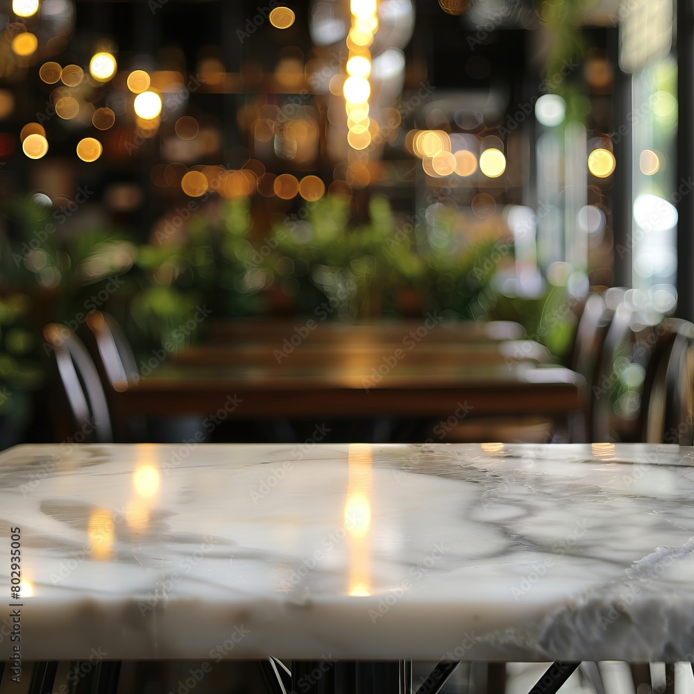 An empty marble table in a restaurant with a blurred background of lights and chairs. An empty marble table in a restaurant with a blurred background of lights and chairs.
