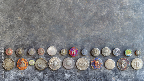 A row of coins with a variety of designs and colors photo