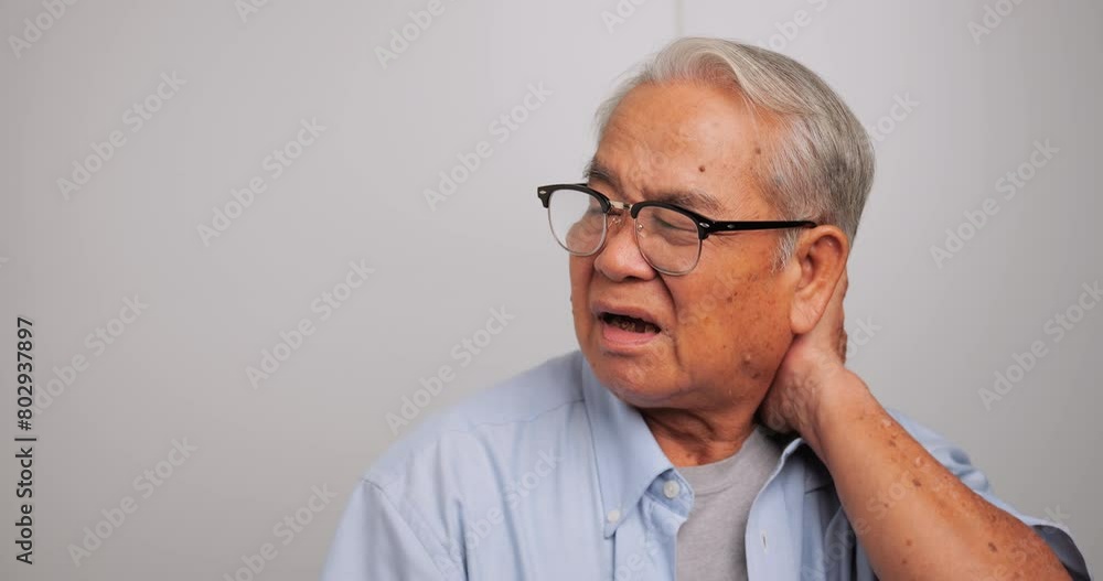 An elderly Asian old man with neck pain. An elderly Asian old man with neck pain.