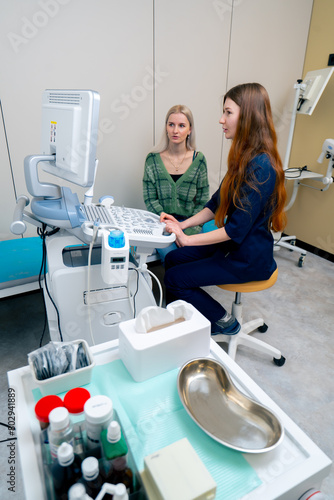 in the clinic a young blonde girl at an appointment with a gynecologist consultation before the examination