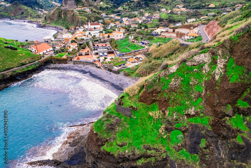 Aerial view of rough ocean with waves, volcanic beach in Porto da Cruz, Madeira, Portugal