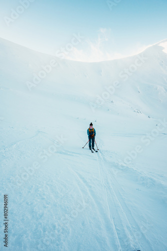 Mountaineer backcountry ski walking ski alpinist in the mountains. Ski touring in alpine landscape with snowy trees. Adventure winter sport. Low Tatras, slovakia © alexanderuhrin