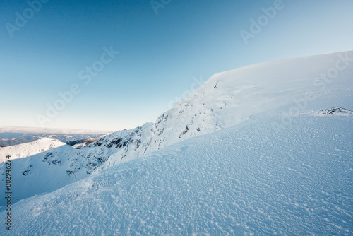 Alpine mountains landscape with white snow and blue sky. Sunset winter in nature. Frosty trees under warm sunlight. Wonderful wintry landscape. Low Tatras, Slovakia © alexanderuhrin