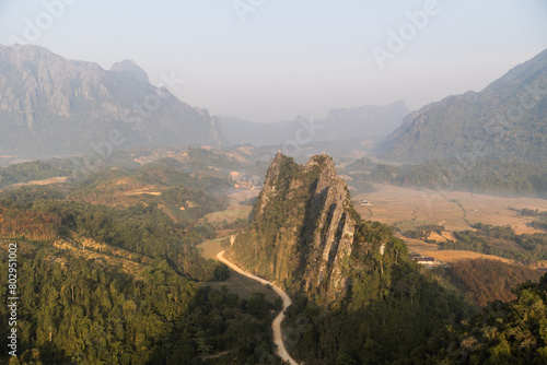 dirt road leading through the valley in Vang Vieng, the adventure capital of Laos