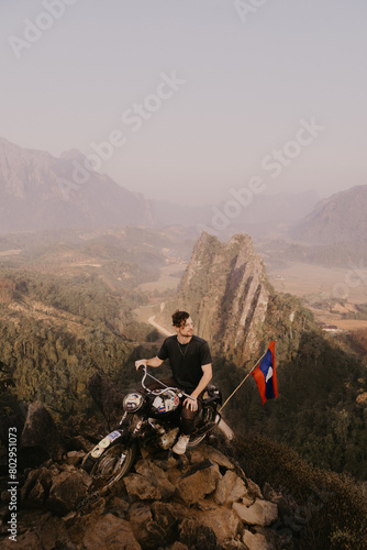 male tourist on top of a motor bike at view point in Vang Vieng, the adventure capital of Laos