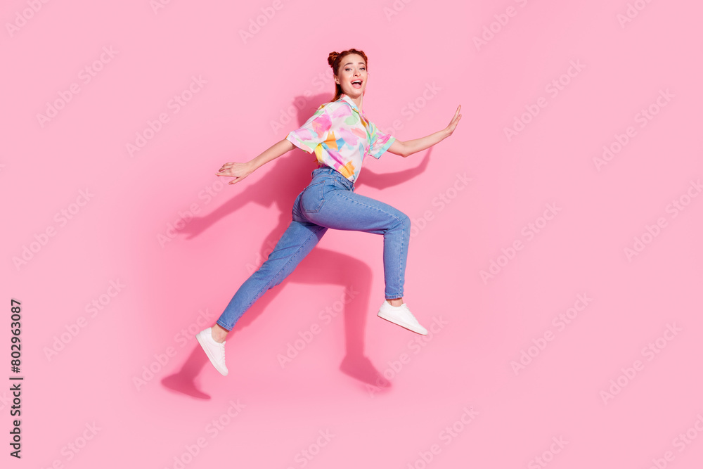 Full length body photo of red hair beautiful girlfriend hipster jumping flying trampoline fast running isolated on pink color background