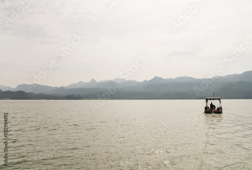 The boat floating on river and mountain is background © Pockey