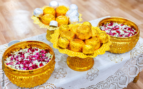 Golden bowl used in rituals in Thailand. Silver bowl in a floating tank with flowers. Used during Songkran festival.