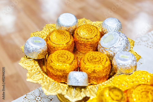 Golden bowl used in rituals in Thailand. Silver bowl in a floating tank with flowers. Used during Songkran festival.