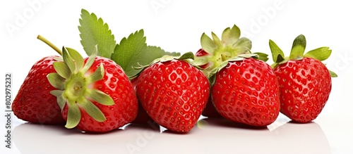 A copy space image featuring isolated strawberries both whole and halved with leaves attached The strawberries are placed on a white background and the set provides a side view of the berries