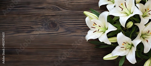 A beautiful arrangement of white lilies on a rustic wooden backdrop The image features a blossoming bouquet with plenty of space for text It is captured from a top down perspective perfect for a gree photo