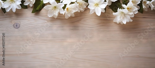 A copy space image featuring white flowers arranged on a wooden floor