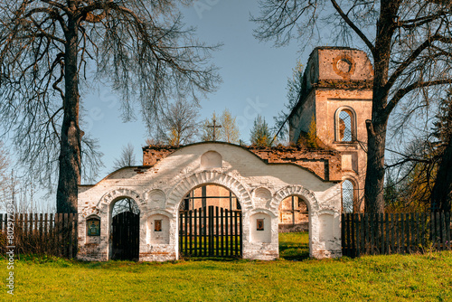 The entrance arched gate in front of the picturesquely crumbling church. Selected Focus photo