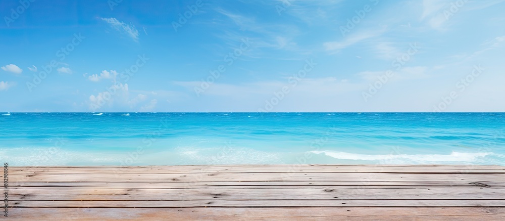 A beach themed copy space image on a blue wooden background representing the concept of travel