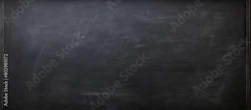 A clean black chalkboard with traces of chalk providing a textured surface for writing or drawing perfect as a copy space image