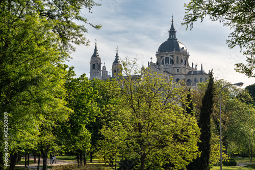 View of the Almudena Cathedral rising from the trees in Spain's capital, Madrid. photo