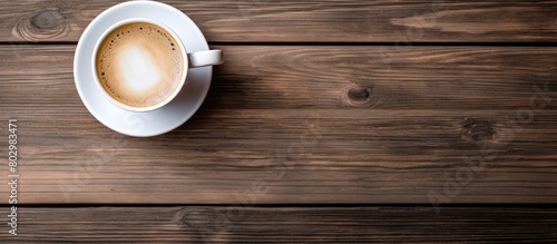 A copy space image of a keyboard and a coffee cup placed on a rustic wooden background