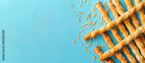 Breadsticks or Salted crackers on a Blue background with Space for adding text on top. photo