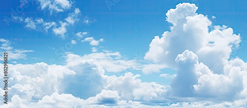 A copy space image with a backdrop of a clear blue sky dotted with fluffy white clouds