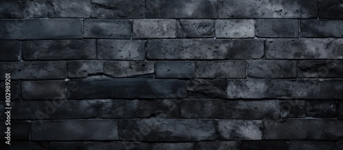 A dark wallpaper featuring a textured old black brick wall providing a design friendly copy space image