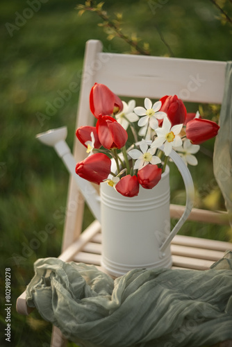 Still-life. Photo of a bouquet of red tulips and daffodils in a spring garden.