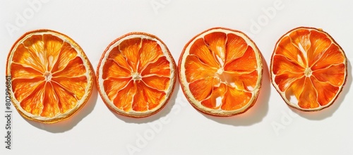 Four dried orange slices arranged in a pattern, seen from above.