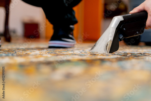 close up professional cleaning of the apartment the a cleaner washes and vacuums the carpet from dirt