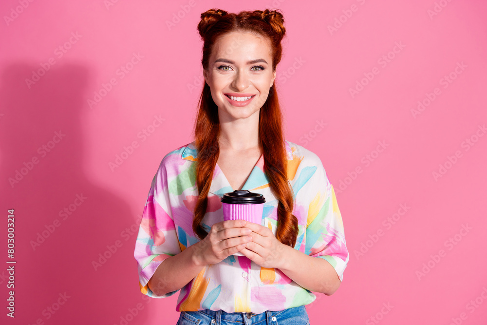 Portrait of toothy beaming adorable woman with foxy hairstyle wear print shirt hold cup of cappuccino isolated on pink color background Portrait of toothy beaming adorable woman with foxy hairstyle wear print shirt hold cup of cappuccino isolated on pink color background