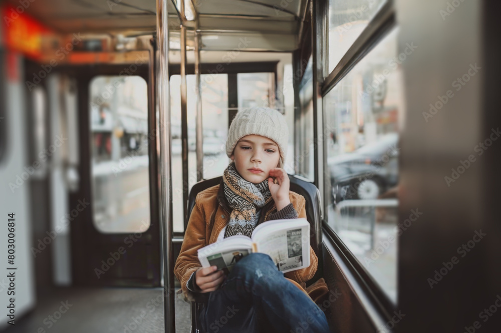 Young Boy Engrossed in Reading While Riding the City Bus, Immersed in a Book Young Boy Engrossed in Reading While Riding the City Bus, Immersed in a Book