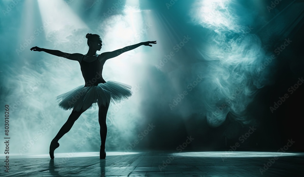 Fototapeta premium Graceful ballerina performing on stage with dramatic lighting