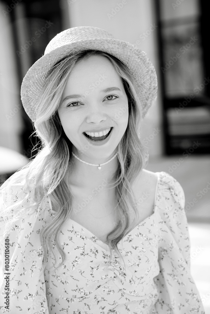 Young beautiful smiling blond woman in trendy summer yellow dress. Sexy carefree woman posing in street at sunset. Positive model outdoors at sunny day. Cheerful and happy. In hat Young beautiful smiling blond woman in trendy summer yellow dress. Sexy carefree woman posing in street at sunset. Positive model outdoors at sunny day. Cheerful and happy. In hat