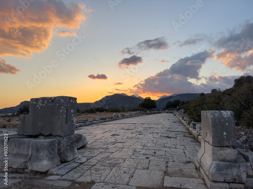 Evening view of the historic ruins of Xanthos, an ancient city and former capital of Lycia, located in Kaş, Antalya, Turkey, under a colorful sunset. photo