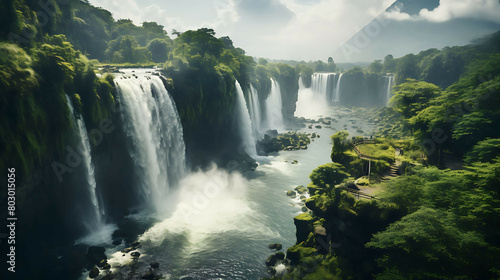 An aerial view of a majestic waterfall cascading into a serene lake  surrounded by lush forests  under the soft light of the early morning sun.