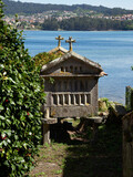 Old granary by the sea with blue sky in Combarro, Galicia, Spain