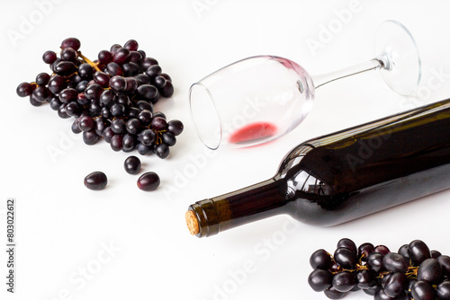 Bottle of wine with wineglass and grapes. Wine background