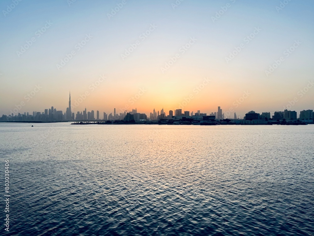 City river at the sunset time, silhouette of the cityscape at the river, twilights