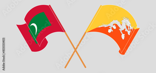 Crossed and waving flags of Maldives and Bhutan