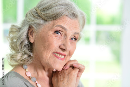 Close-up portrait of a beautiful older woman posing at home