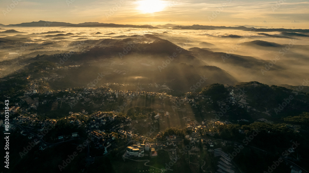 The morning sun peeks through the fog over rolling hills, casting long shadows across the landscape. The morning sun peeks through the fog over rolling hills, casting long shadows across the landscape.
