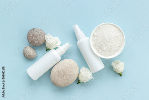 Layout of white cosmetics products and roses flowers, top view © 9dreamstudio