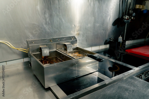 professional kitchen with a double fryer in which French fries are fried