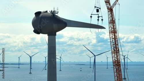 Wind turbine construction works with rows of wind turbines in an offshore windpark in The Netherlands.