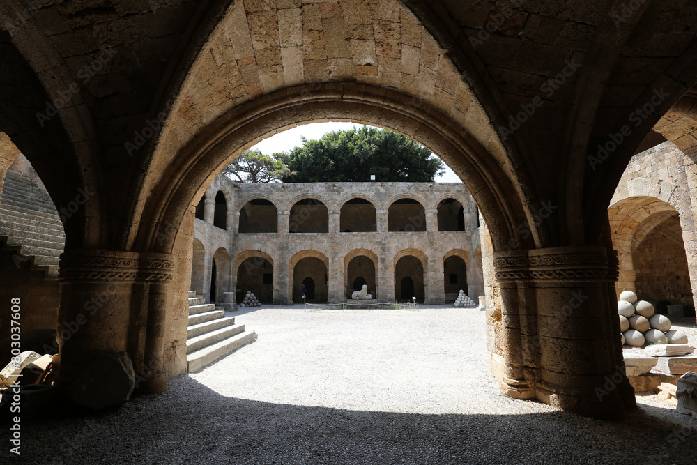 Rhodes, Greece - August 10, 2017: Archaeological museum, arches, stone building, medieval old european architecture Rhodes, Greece - August 10, 2017: Archaeological museum, arches, stone building, medieval old european architecture