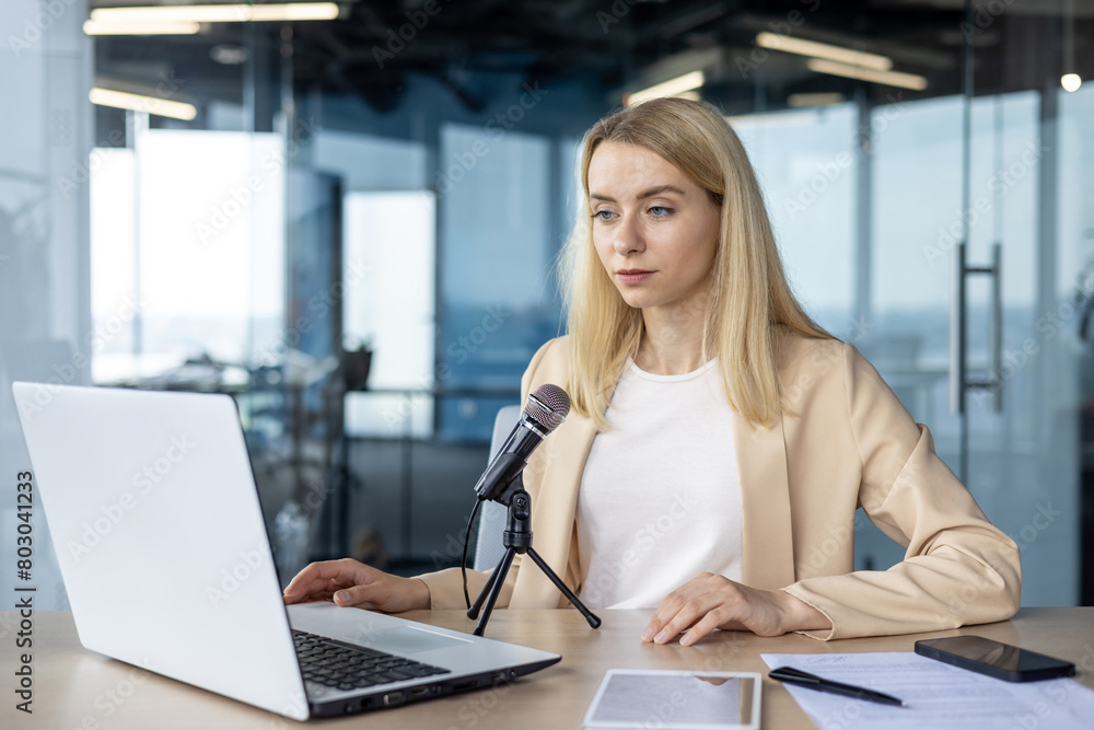 Professional woman recording a podcast in a modern office Professional woman recording a podcast in a modern office