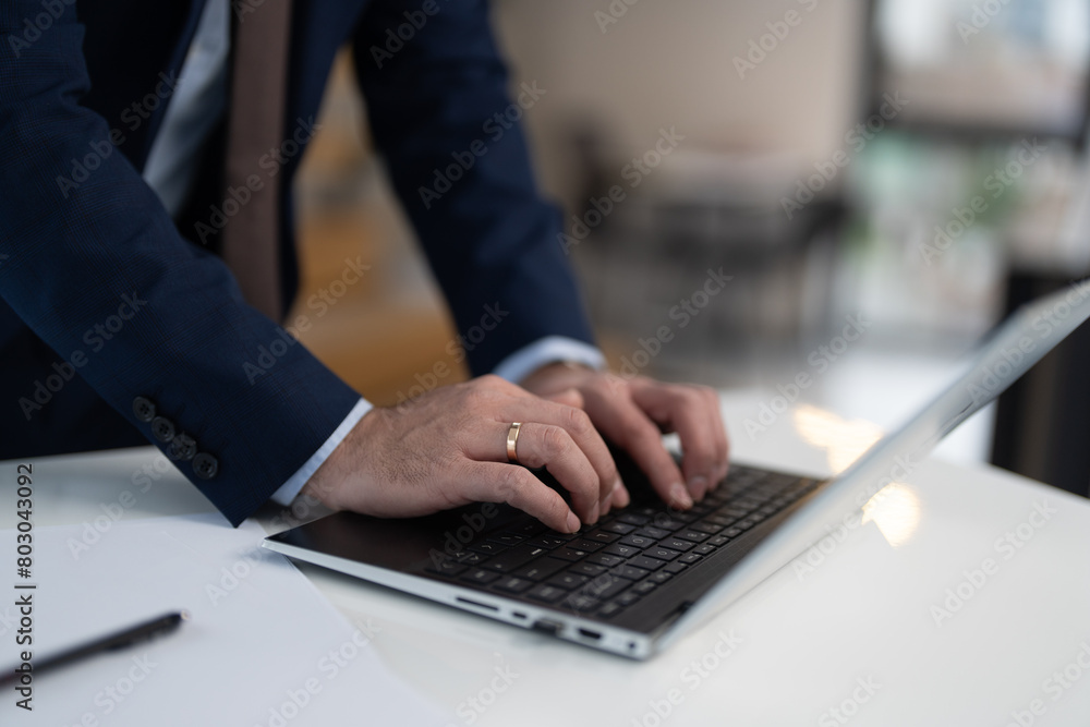 Close up view of businessman typing on laptop Close up view of businessman typing on laptop